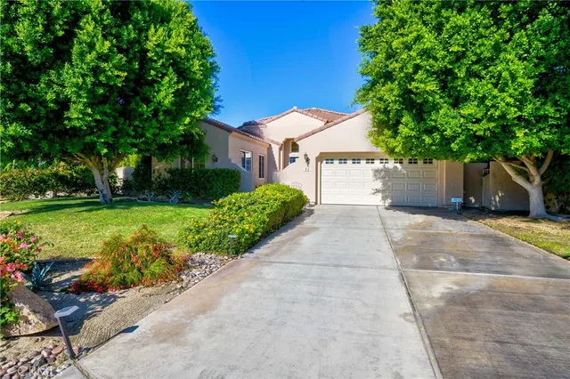 a front view of a house with a yard and a garage