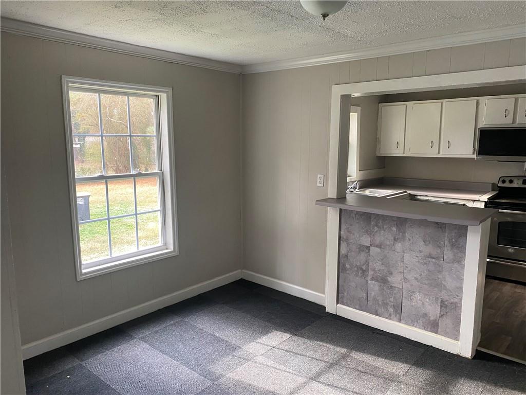 2201 Southern Street Northeast Rome, GA 30161 - Photo 5 of 9 a kitchen with a stove a sink and a window