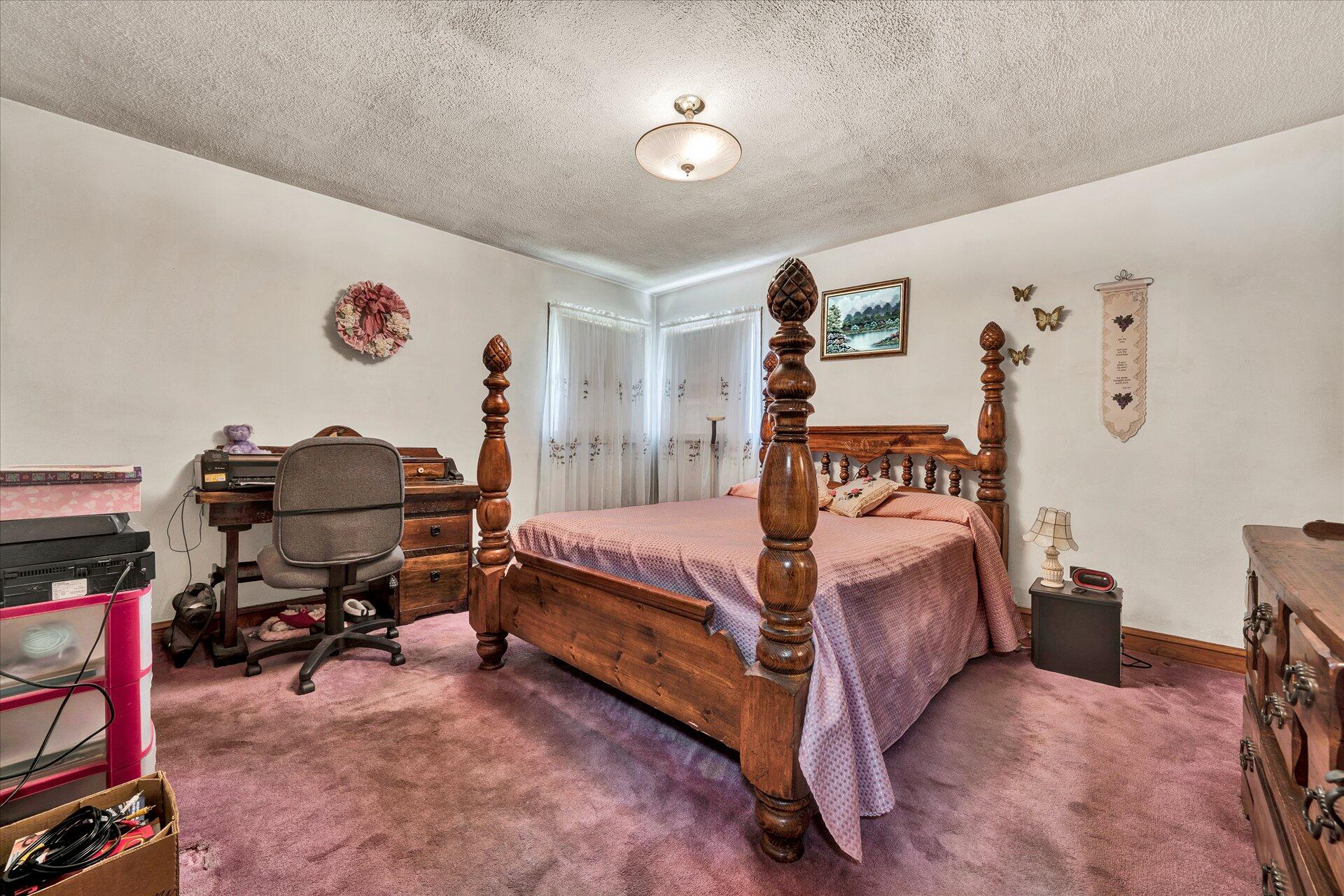 950 Thompson Ridge Road Ferrum, VA 24088 - Photo 17 of 31 a bed room with a bed and a chair