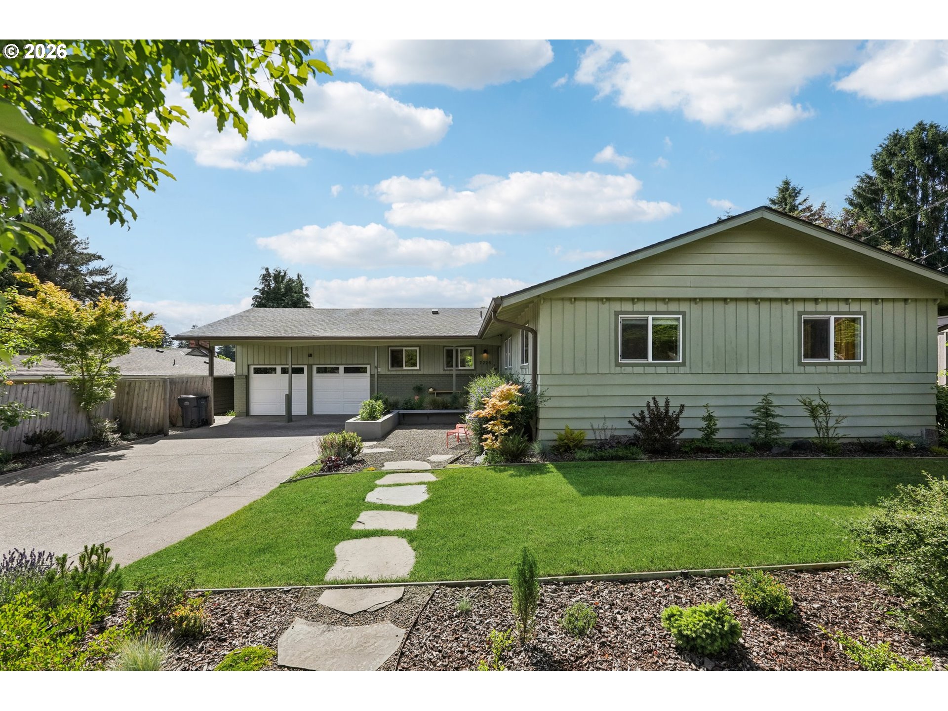 7225 Southwest 13th Avenue Portland, OR 97219 - Photo 2 of 48 a front view of a house with a yard and garage