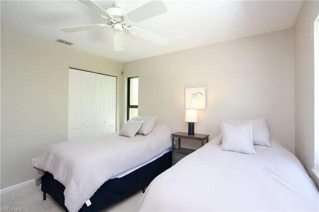 a bedroom with two beds and a chandelier