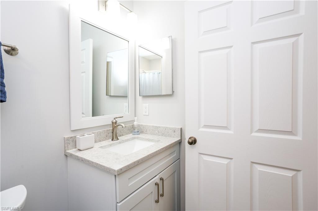 5733 Deauville Circle, Unit G308 Naples, FL 34112 - Photo 14 of 50 a bathroom with a sink and a toilet