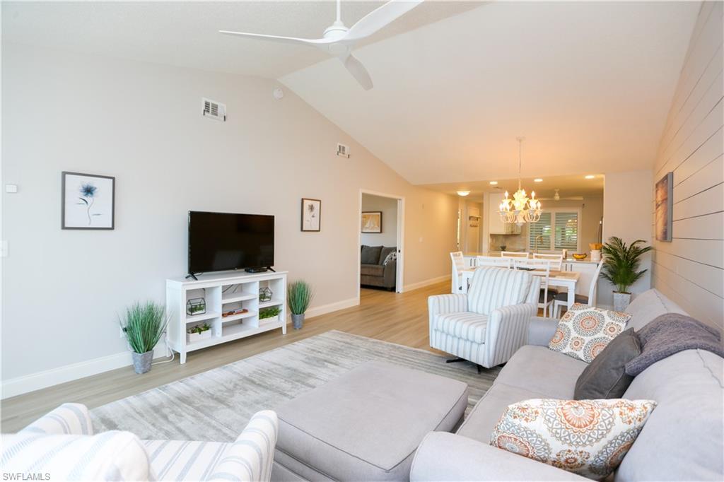 5733 Deauville Circle, Unit G308 Naples, FL 34112 - Photo 22 of 50 a living room with furniture and a flat screen tv