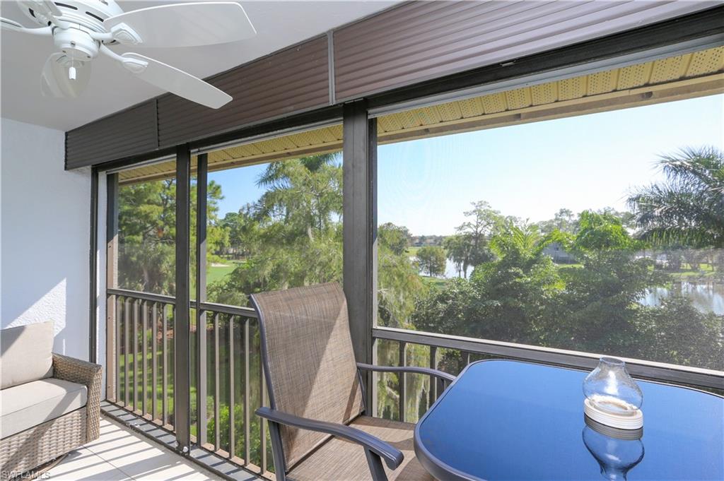 5733 Deauville Circle, Unit G308 Naples, FL 34112 - Photo 28 of 50 a view of a chairs and table in the balcony