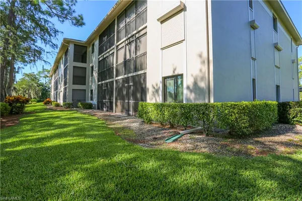 a view of a building with a yard