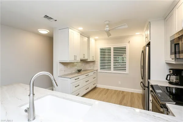 a spacious bathroom with a sink a bathtub and a window