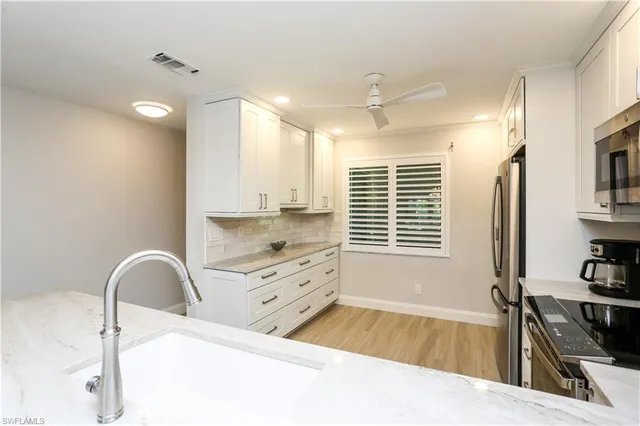 a spacious bathroom with a sink a bathtub and a window