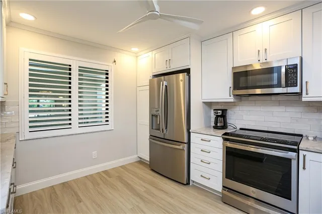 a kitchen with stainless steel appliances a stove microwave and a refrigerator