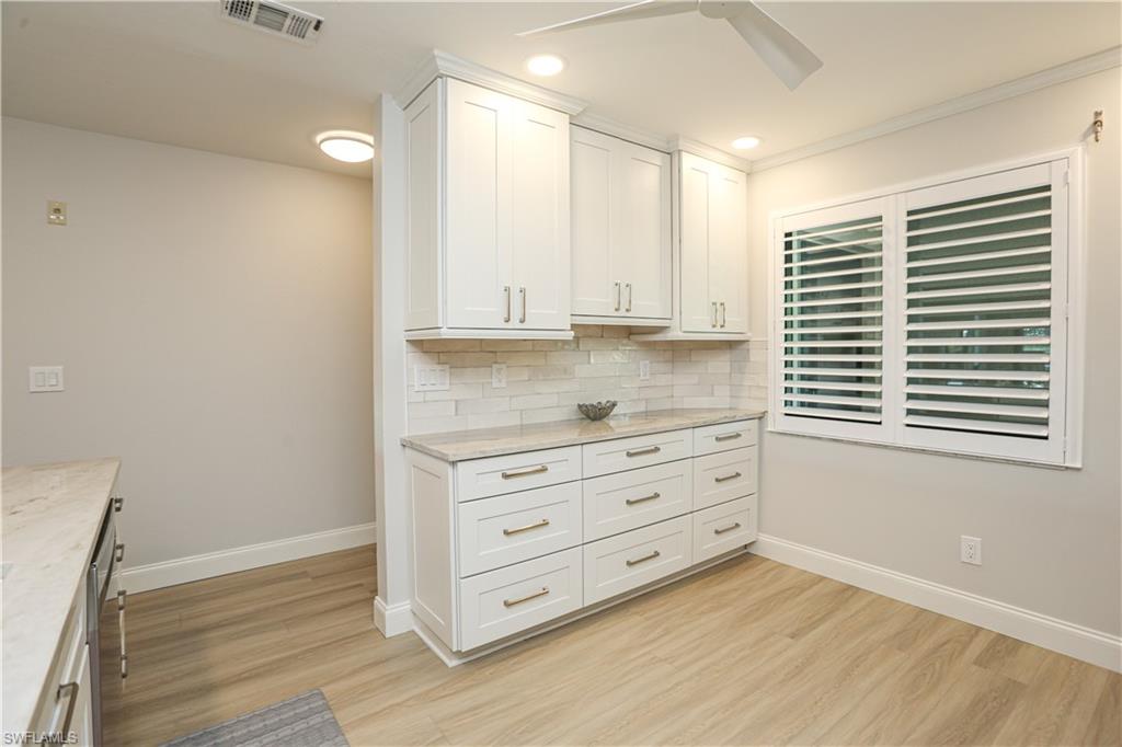 5733 Deauville Circle, Unit G308 Naples, FL 34112 - Photo 35 of 50 a view of cabinet and window in a room