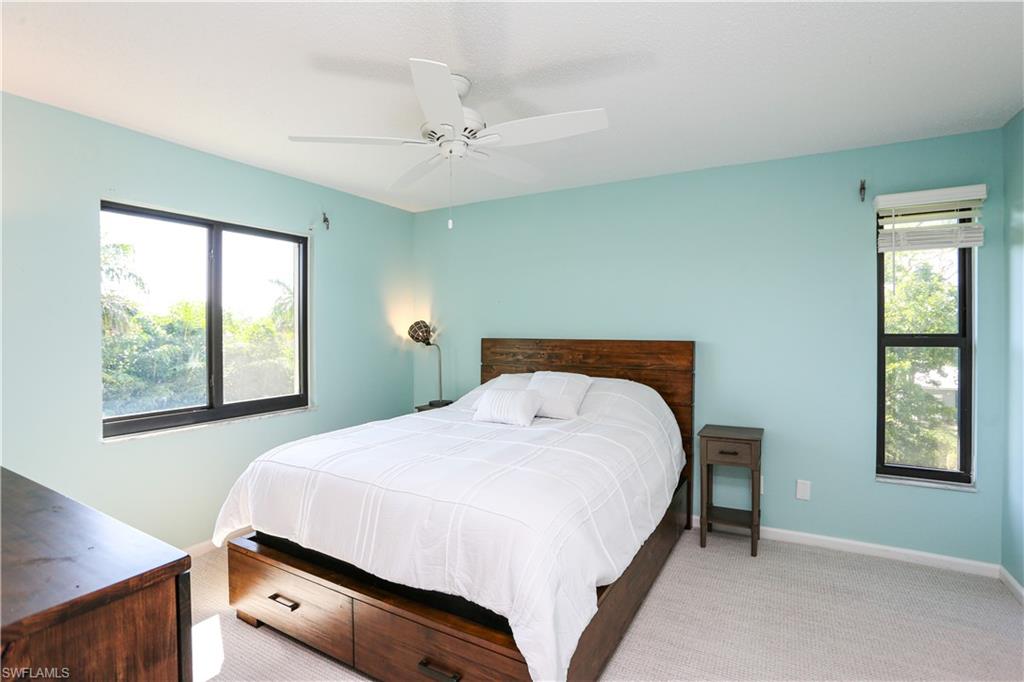 5733 Deauville Circle, Unit G308 Naples, FL 34112 - Photo 39 of 50 a bedroom with a bed and a window