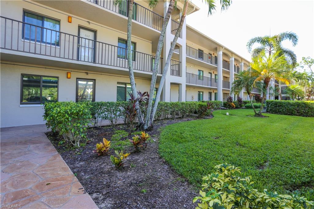 5733 Deauville Circle, Unit G308 Naples, FL 34112 - Photo 4 of 50 a view of a building with a garden