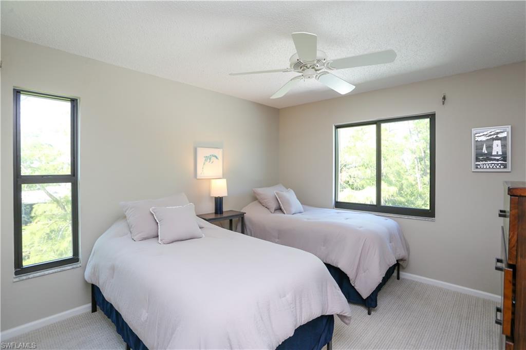 5733 Deauville Circle, Unit G308 Naples, FL 34112 - Photo 10 of 50 a bedroom with two beds and two windows