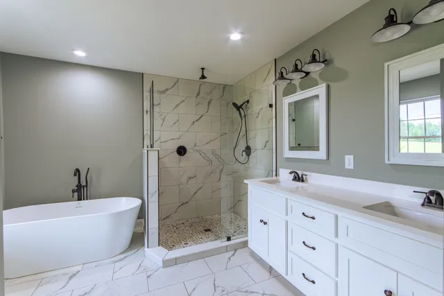 a bathroom with a double vanity sink toilet and shower
