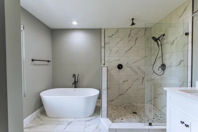 a bathroom with a bathtub and shower