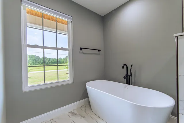 a white bath tub sitting next to a window