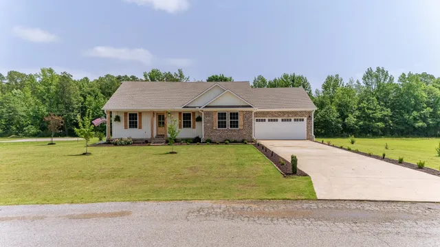 a aerial view of a house with swimming pool and a yard