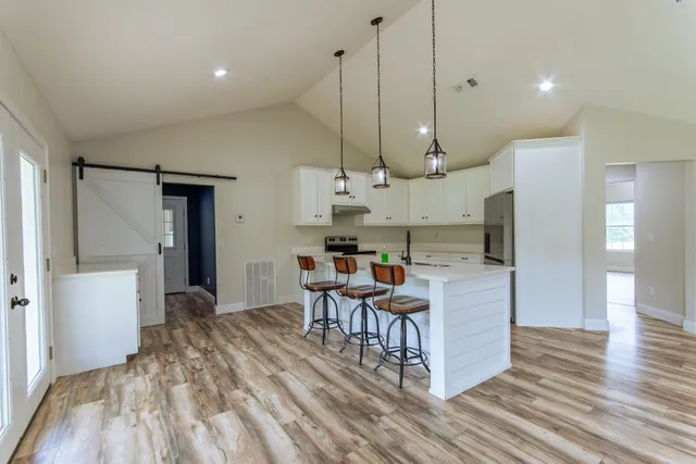 a open kitchen with stainless steel appliances granite countertop a stove and a refrigerator