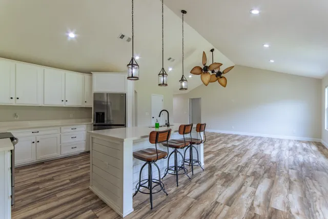 a view of a kitchen and dining room with wooden floor