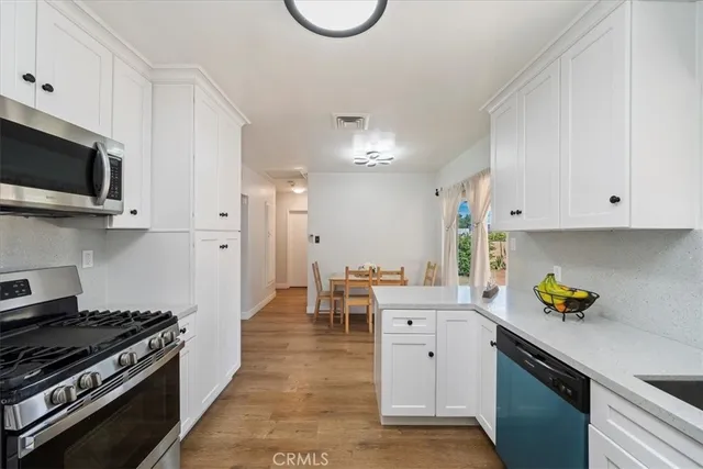 a kitchen with a sink a stove and cabinets