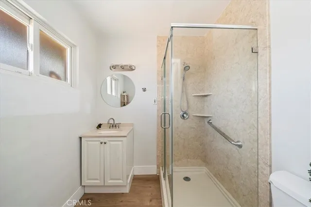 a bathroom with a shower a sink and a mirror