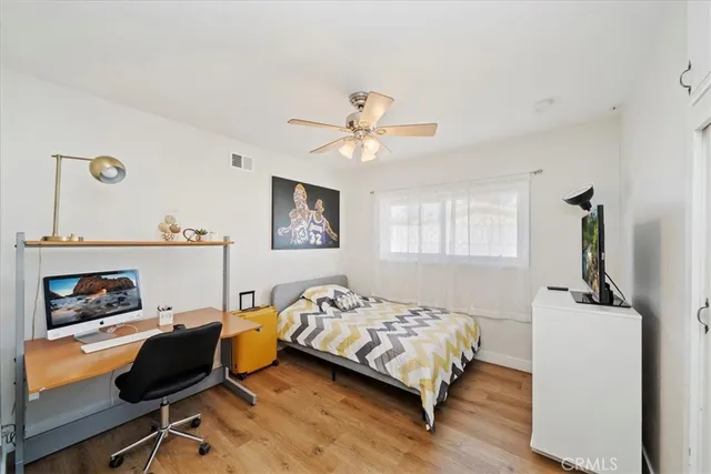 a bedroom with a bed and a chair