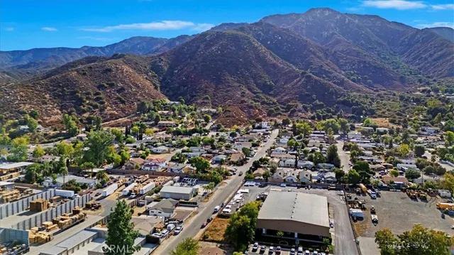 an aerial view of a house with a garden and lawn chairs