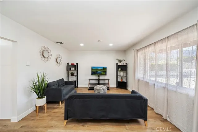 a living room with furniture window and wooden floor