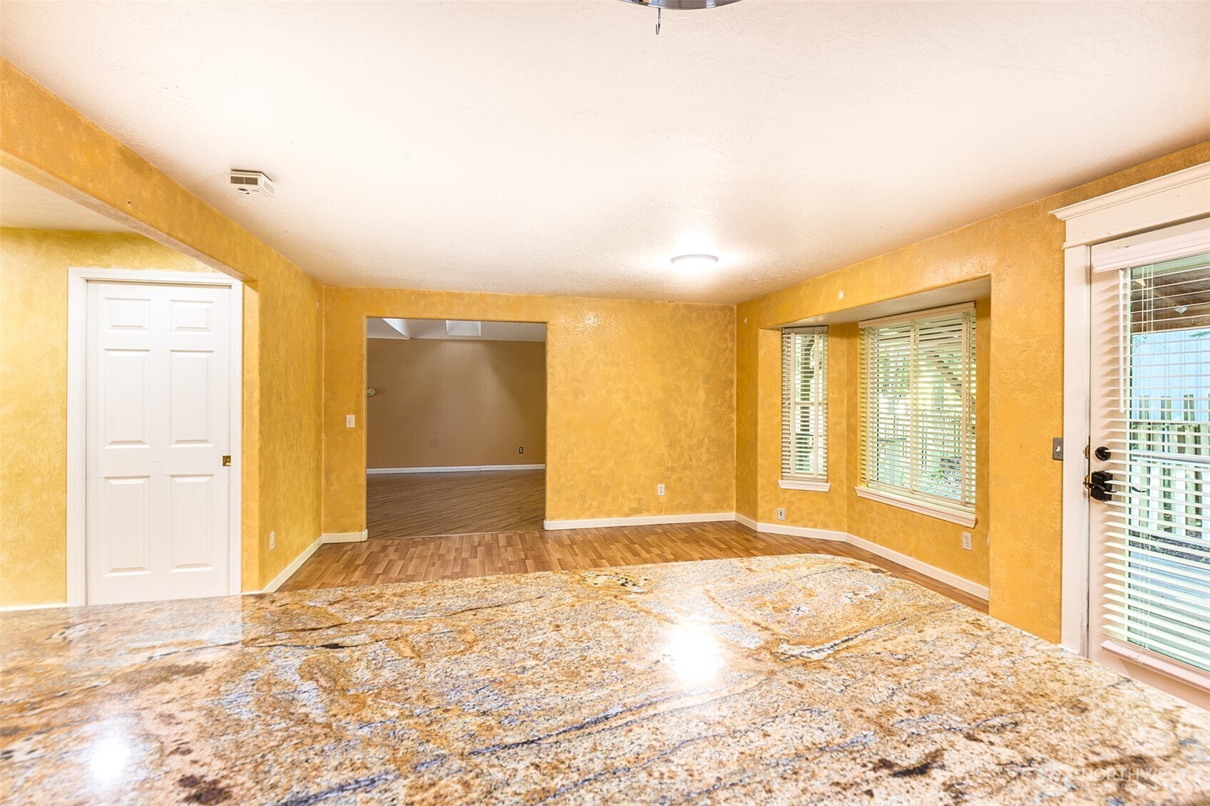 123 Forest Ridge Drive Sequim, WA 98382 - Photo 21 of 32 a view of an empty room with wooden floor and a window