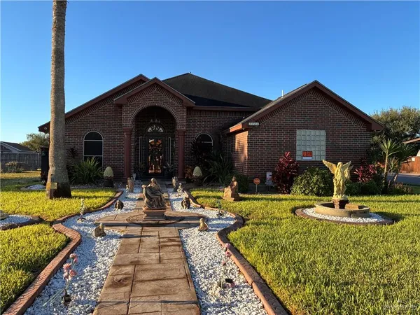 a view of a house with garden and swimming pool