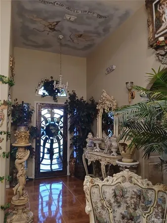 a view of a dining room with furniture a chandelier and wooden floor