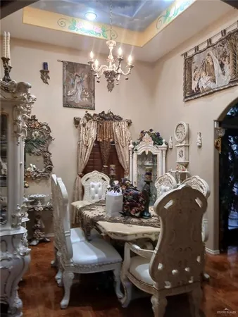 a view of a dining room with furniture and chandelier