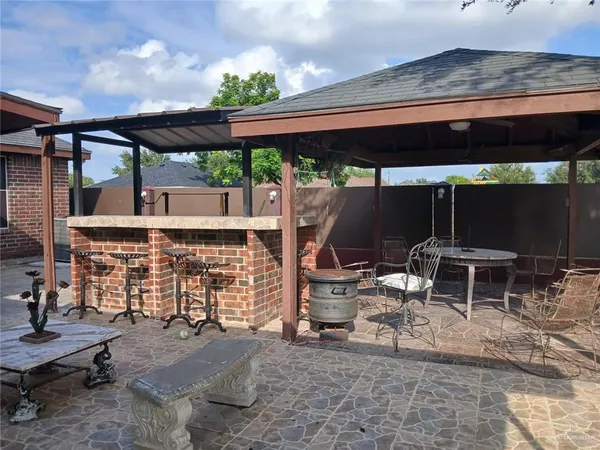 a view of a chairs and table in patio