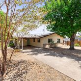 a view of a house with a tree in the background