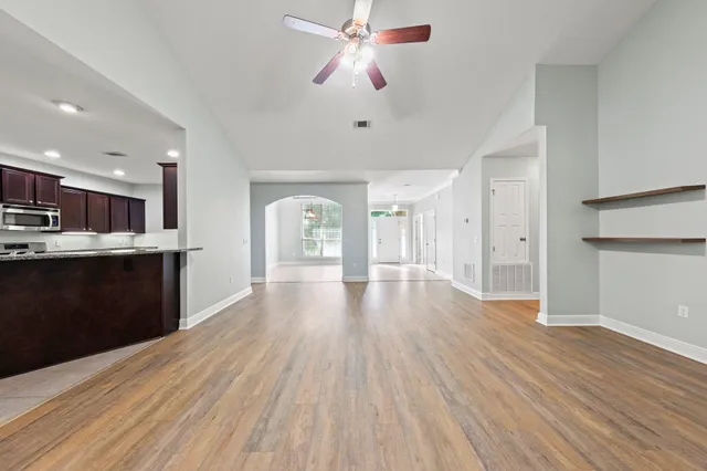a view of an empty room and wooden floor