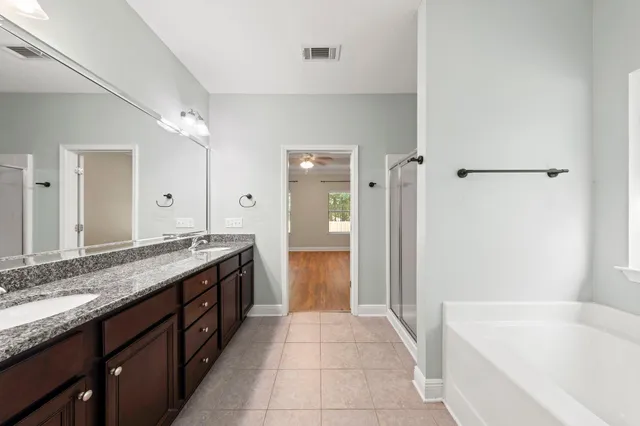 a bathroom with a bathtub and a shower