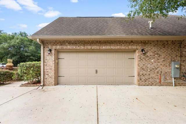 front view of a stone house with a large parking space