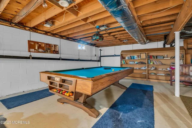 a room with pool table and windows