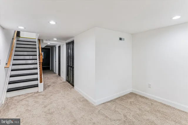 a view of entryway with stairs and white walls
