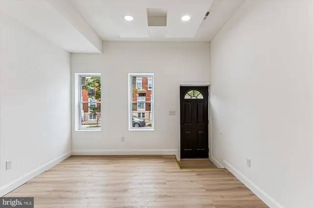an empty room with windows and closet