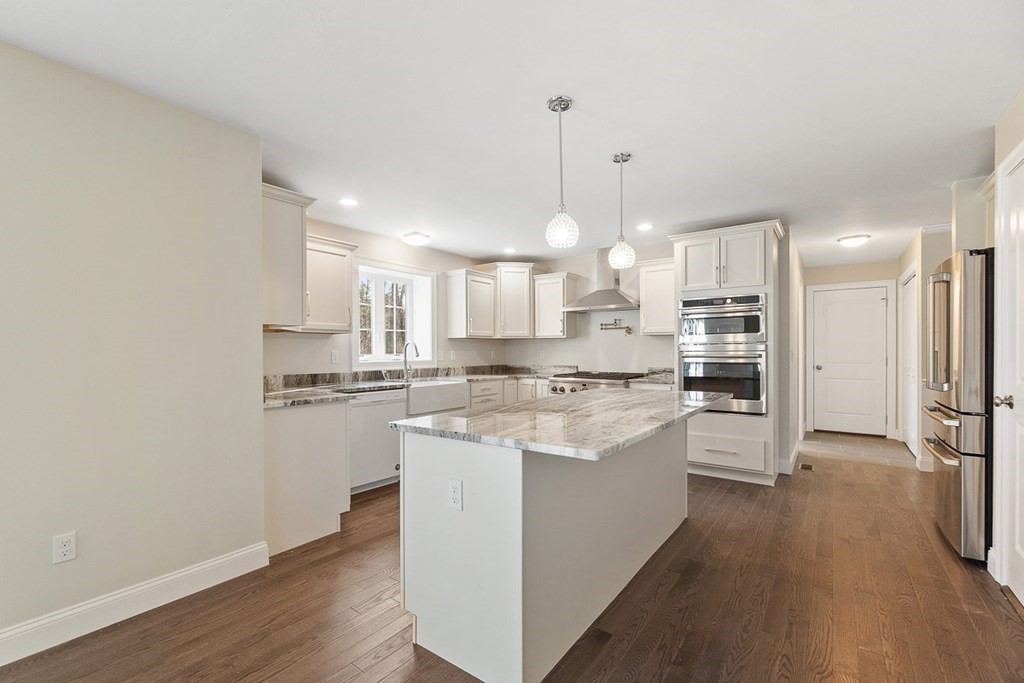 213 Worcester Road Princeton, MA 01541 - Photo 11 of 36 a large kitchen with kitchen island a stove a sink a refrigerator and white cabinets