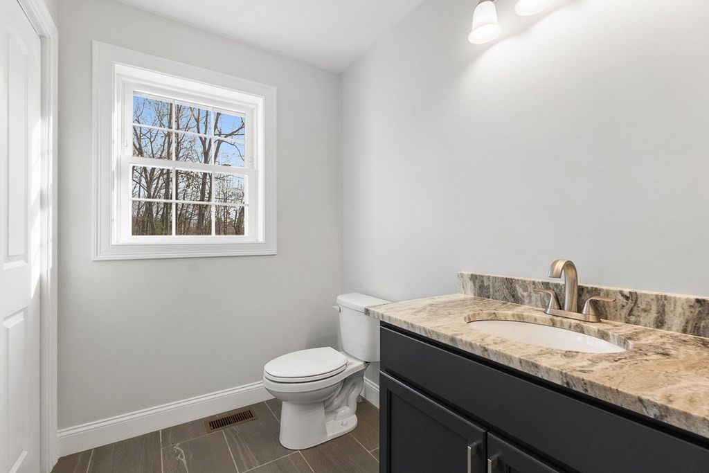 213 Worcester Road Princeton, MA 01541 - Photo 8 of 36 a bathroom with a granite countertop sink toilet and a mirror