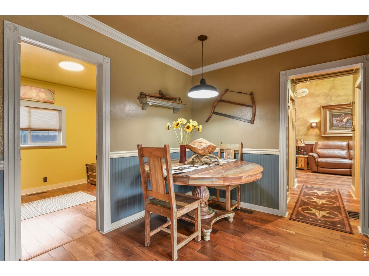 417 2nd Street Fort Lupton, CO 80621 - Photo 9 of 24 a view of a dining room with furniture and a chandelier
