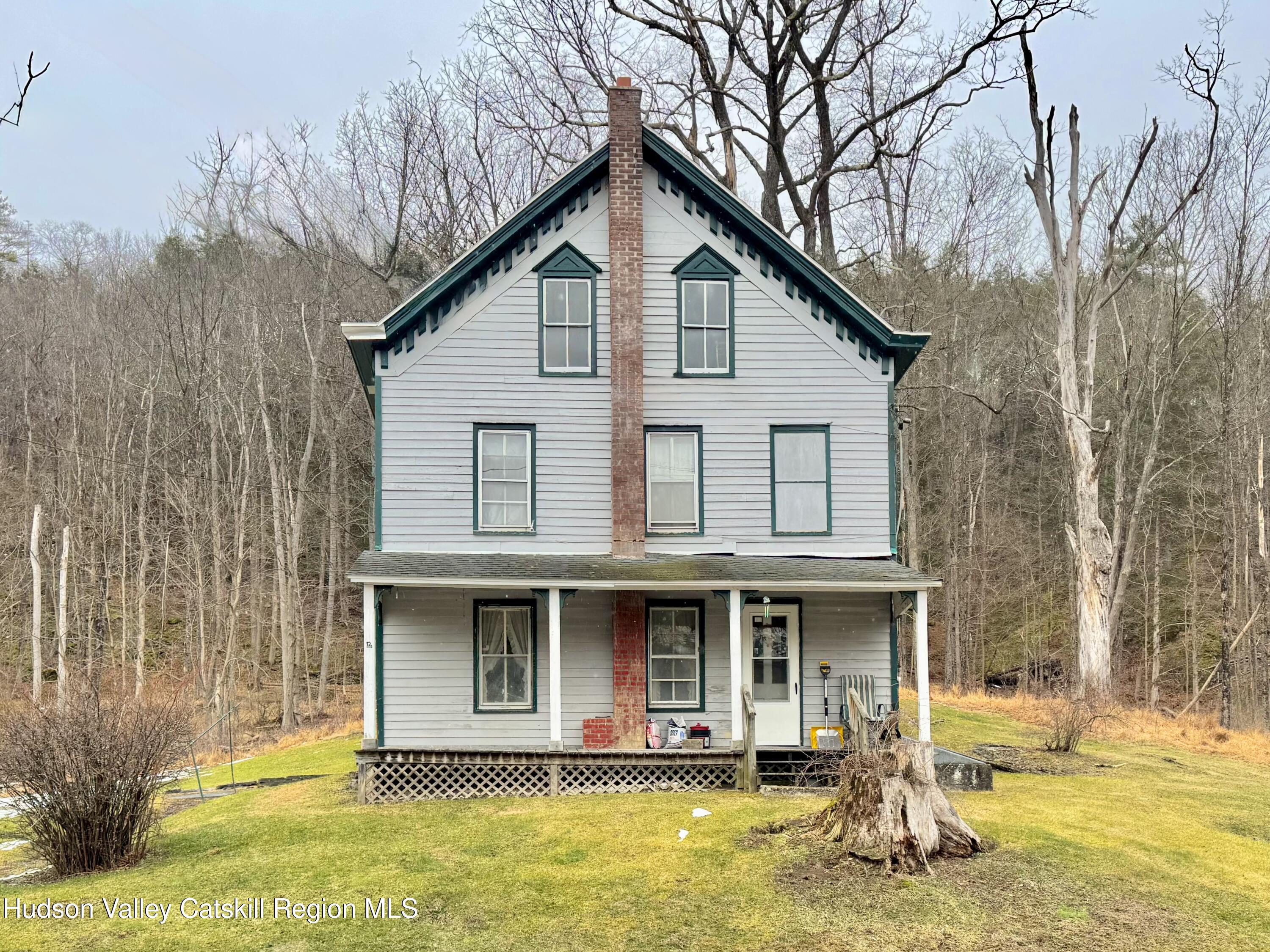 5208 Cauterskill Road Catskill, NY 12414 - Photo 1 of 23 a view of a white house with large windows and a small yard
