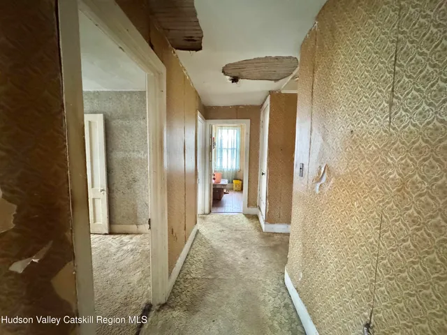 a view of a hallway with wooden shelves