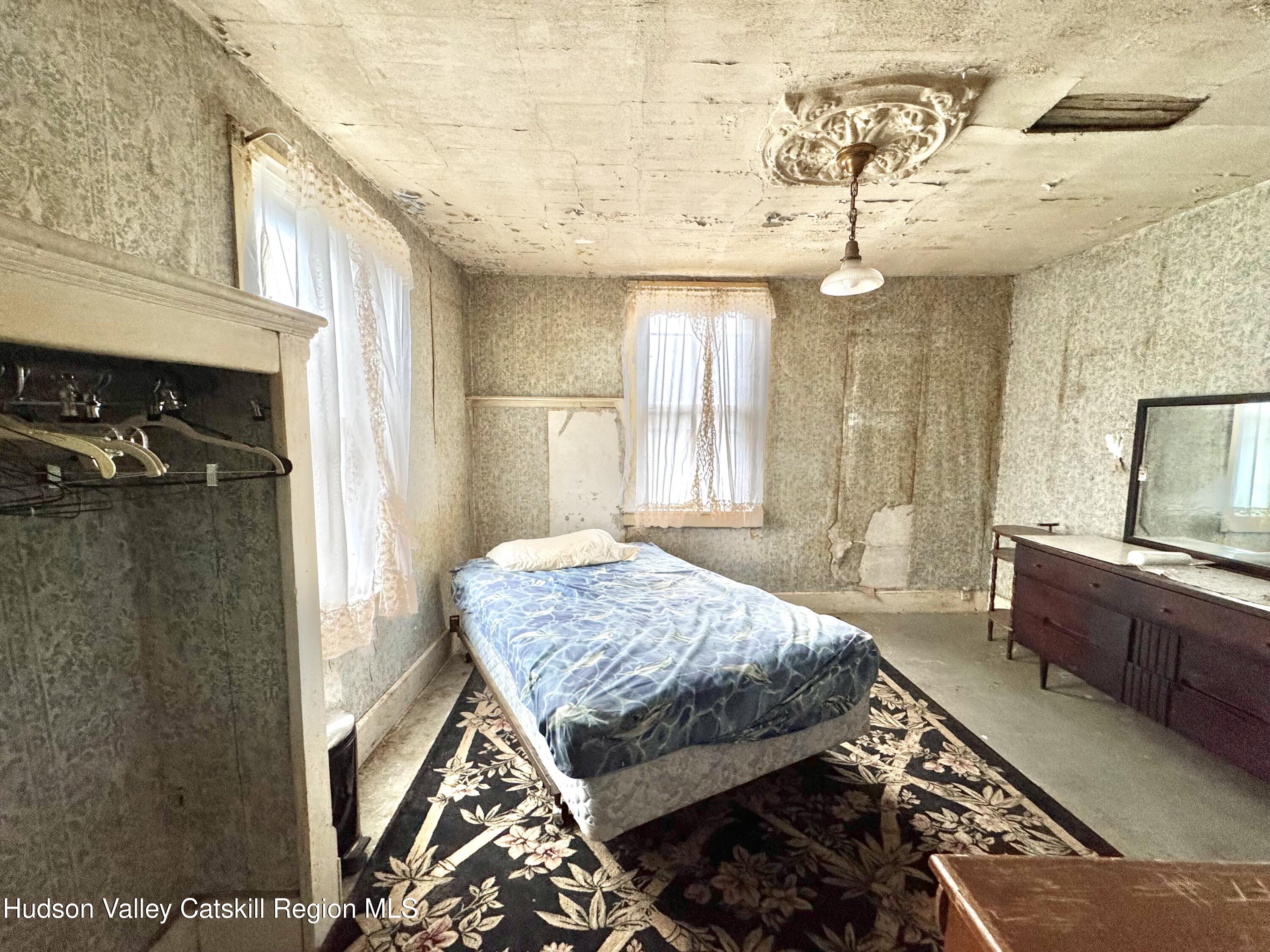 5208 Cauterskill Road Catskill, NY 12414 - Photo 13 of 23 a bedroom with a bed and a dresser