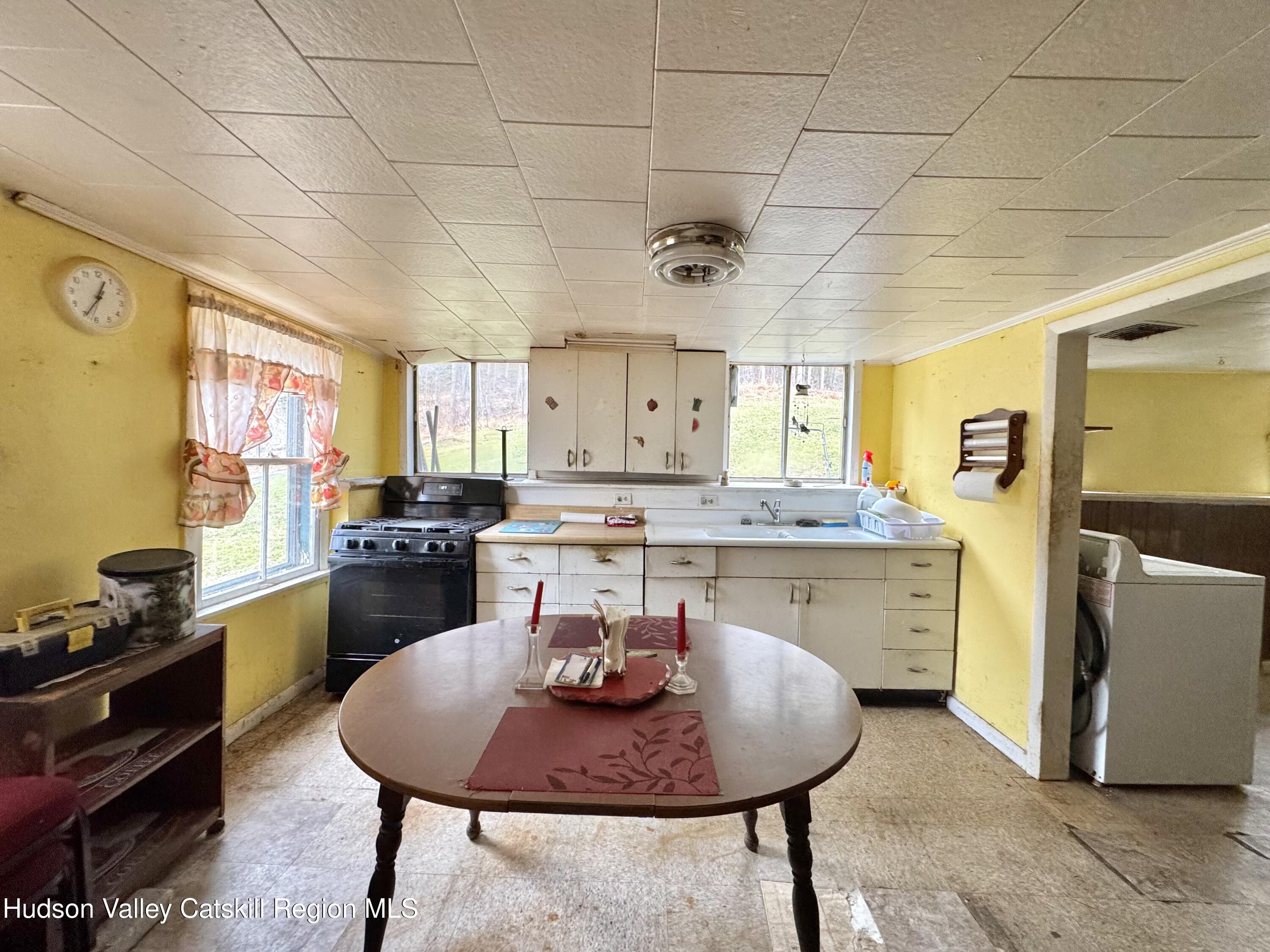 5208 Cauterskill Road Catskill, NY 12414 - Photo 9 of 23 a living room with stainless steel appliances kitchen island granite countertop furniture and a kitchen view