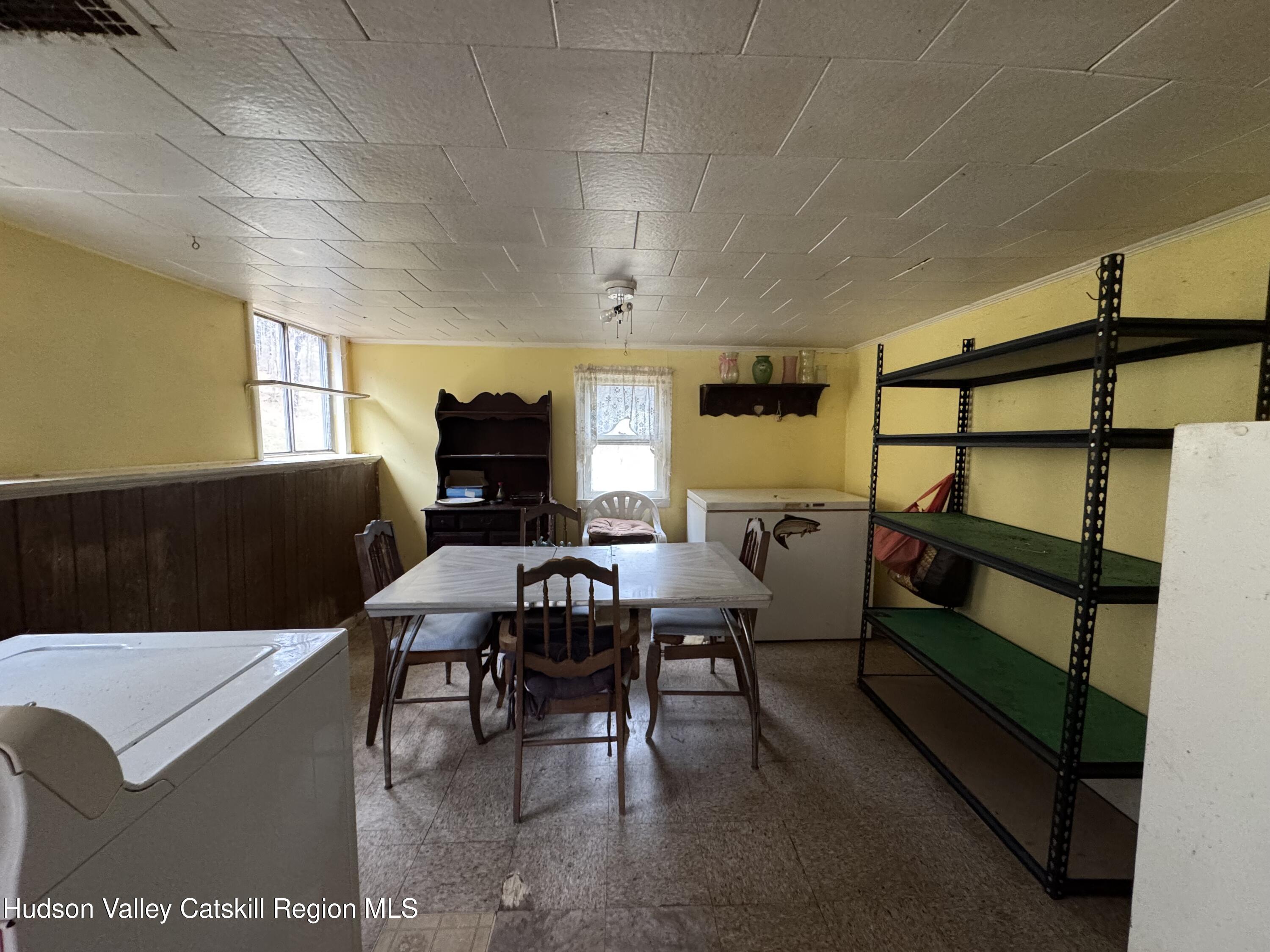 5208 Cauterskill Road Catskill, NY 12414 - Photo 10 of 23 a living room with furniture a desk and chair with the wooden floor