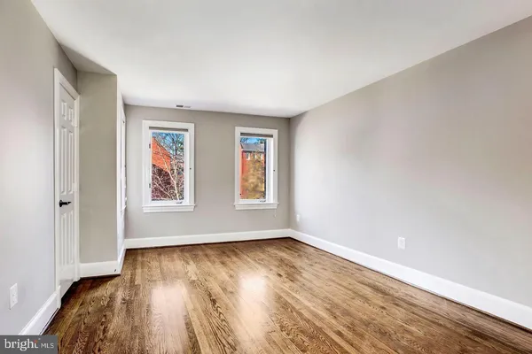 wooden floor in an empty room with a window