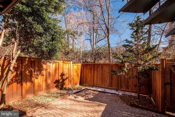 a view of backyard with wooden fence