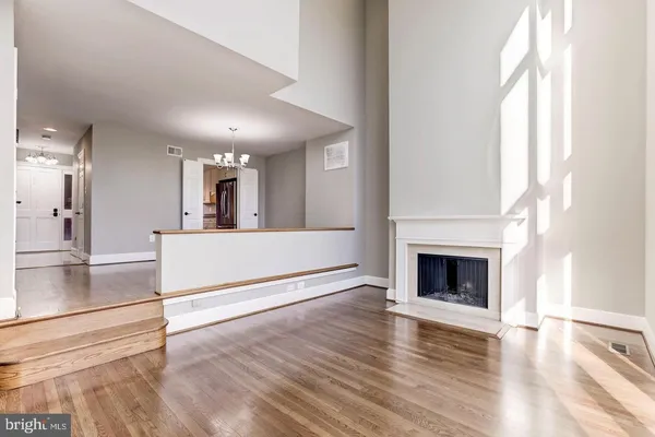 a view of a kitchen with a sink a fireplace and wooden floor